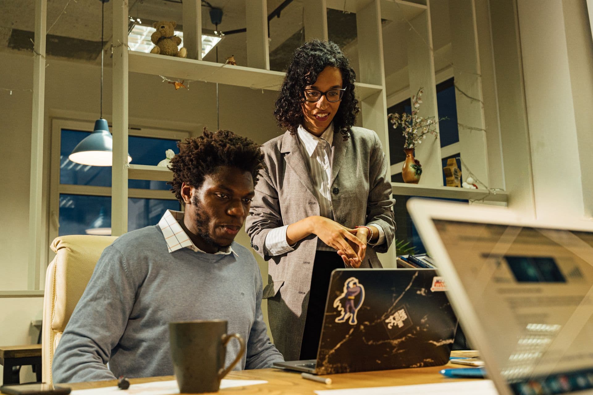 Two developers reviewing work on a laptop